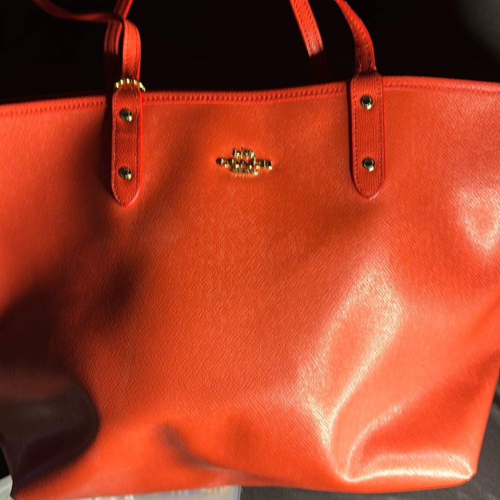 So this is a dual Coach bag. It’s orange or you can turn it into the brown side